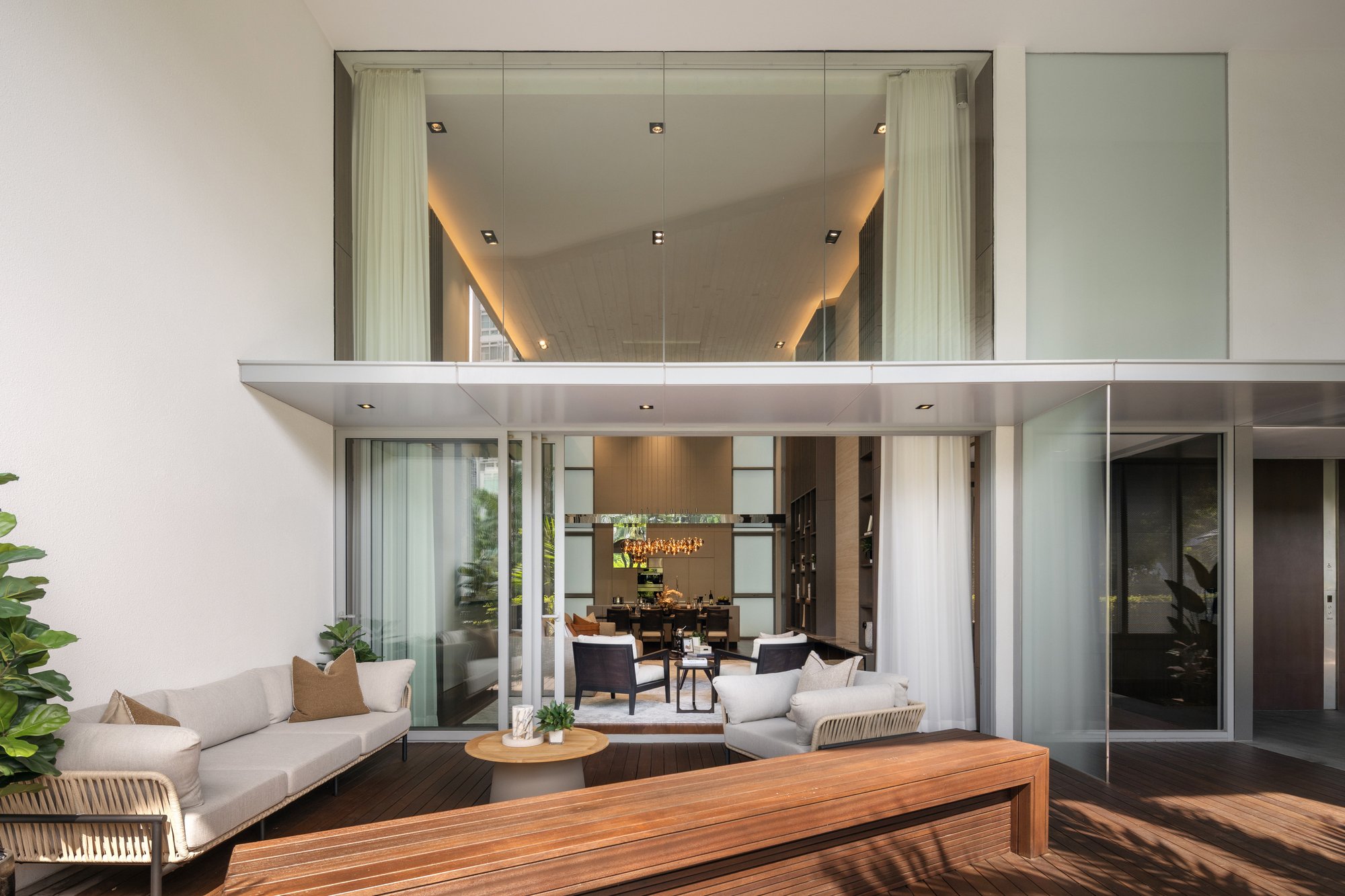 Ground-floor courtyard living pavilion opening onto a timber deck